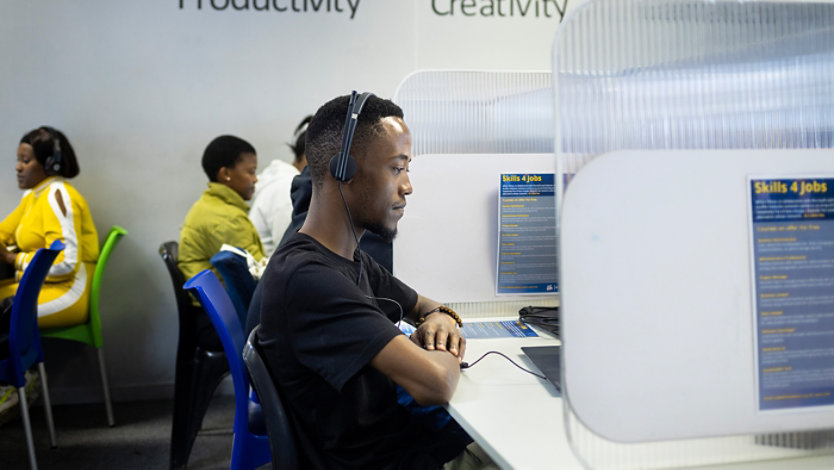 People working at computers in a job skills training center.