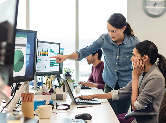 Two people working together at a desk.