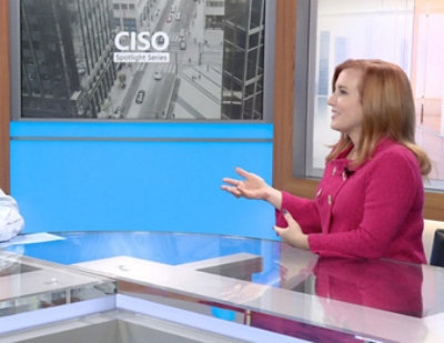 Theresa Payton and Bret Arsenault seated at a counter in a professional studio setting with CISO Spotlight Series and CISO city image in background.