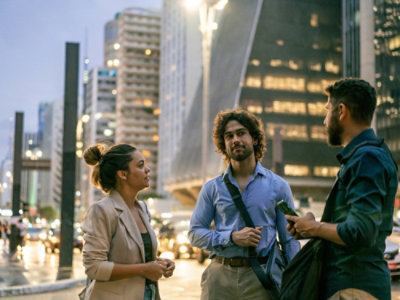 A group of people standing in a city.