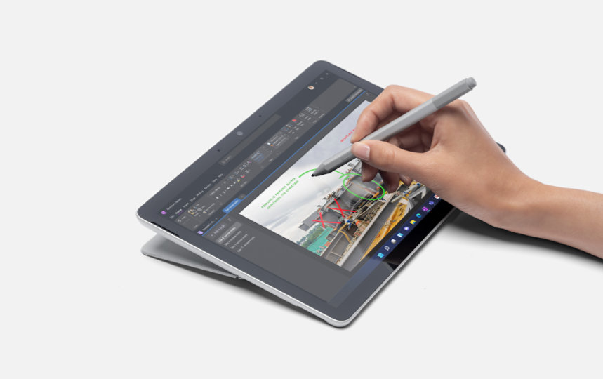 A person uses a Surface Pen for Business to write on the touchscreen of a Surface Go 4 for Business. 