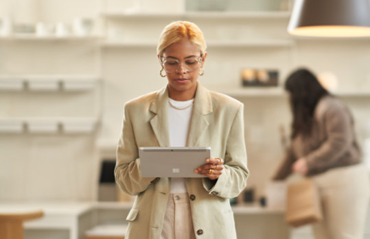 A woman using a Surface device in a retail shop.
