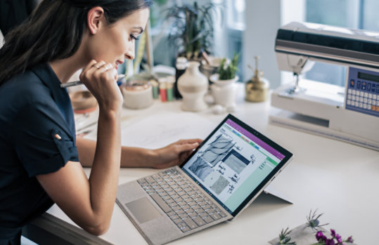 A person uses the touch pen with her Surface Pro.