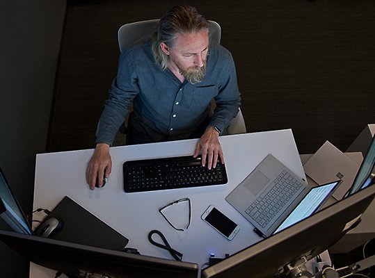 A top-down view of a person working at their desk.