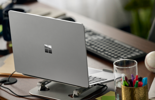 A tablet displays the Microsoft 365 home page.