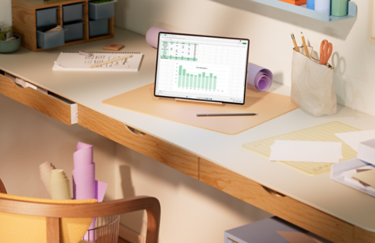 A tablet shows Excel in a home office.