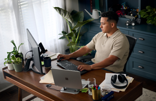 A woman works on a Dell laptop.