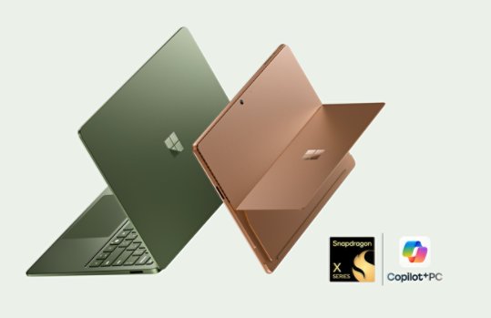 The latest edition Surface PCs—a floating Surface Laptop in the color Jade and a floating Surface Pro in the color Dune. 