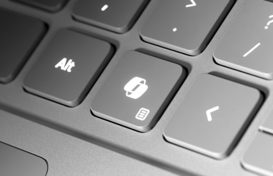 A close-up of the dedicated Copilot key on a Surface Laptop for Business’s keyboard.