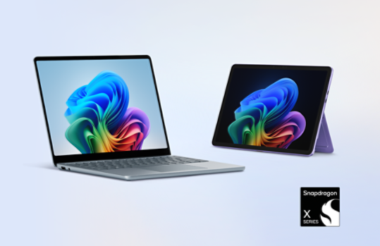 Image of an ocean Surface Laptop with a violet Surface Pro in kickstand mode and a badge for Snapdragon X in the corner.