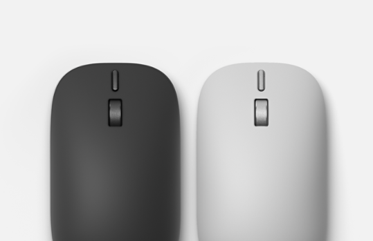 Widok z góry na Mysz Surface (2. edycja) w kolorze platynowym i czarną Mysz Surface (2. edycja) leżące obok siebie.