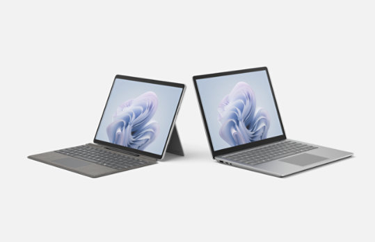 A Surface Laptop and a Surface Go device attached to a Surface Pro Keyboard.