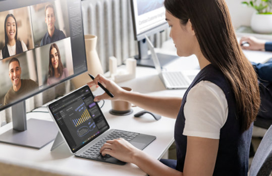 A person holding a Surface Slim Pen joins a video call using Surface Pro and Surface Pro 12-inch Keyboard.