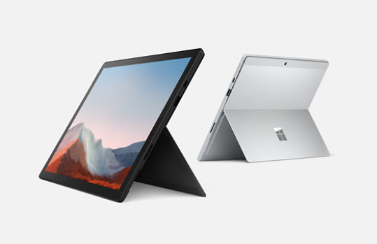 Two Surface Pro Sevens, one in black facing front, and one in silver showing back view. 