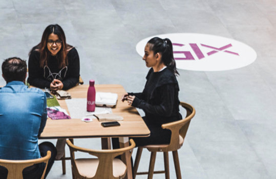 Three people are having a discussion.