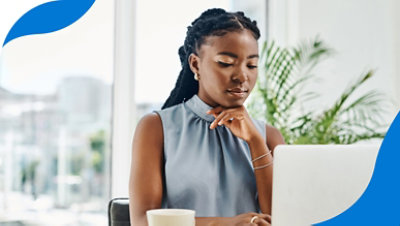 Una persona con la mano en la barbilla mirando un portátil