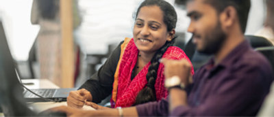 A woman smiling while looking at the desktop
