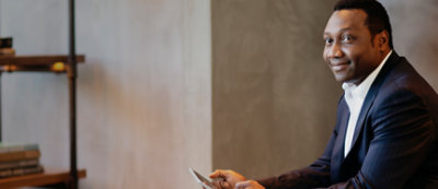 A man is sitting and using mobile