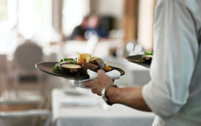 A person holding a plate of food