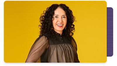 Image of Gabriela standing with a smile on her face and her hands on her hips