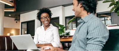 A man and a woman looking at a laptop.
