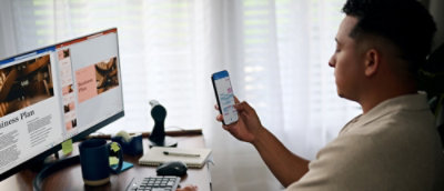 Person editing a presentation across desktop and mobile devices.