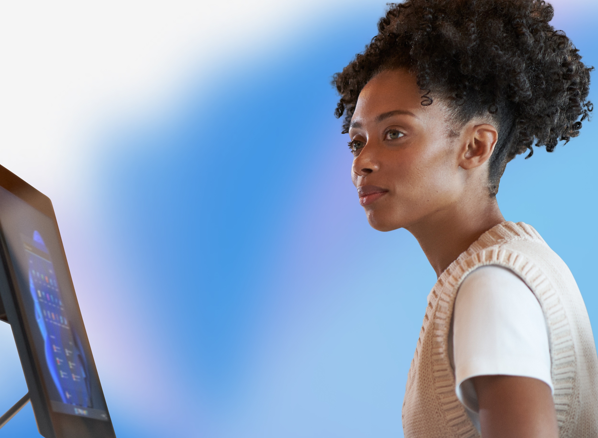 A woman looking at a computer screen.