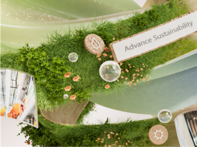 Díszes zöld installáció fűvel és virágokkal, amelyen gombok és az „A fenntarthatóság előmozdítása” szöveg láthatók.
