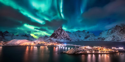 The northern lights shining above a small town.