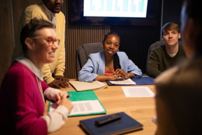 People collaborating during a meeting around a conference table.
