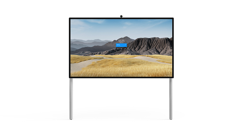 Un Surface HUB 2S 85'' sobre un soporte de pared con soporte para el suelo.