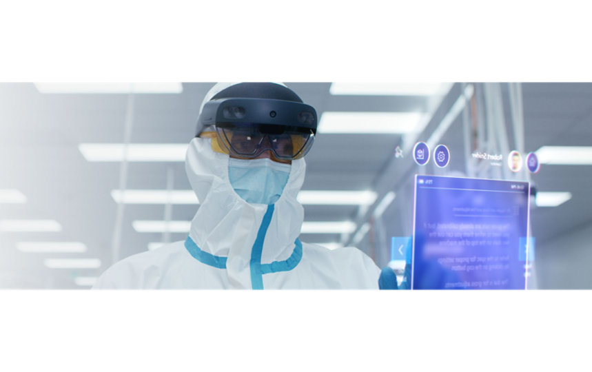 A person in a hazmat suit wears a HoloLens 2 Industrial Edition device.