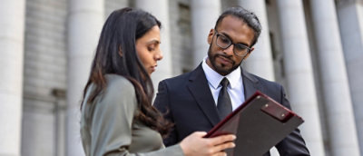 A man and woman looking at the clipboard.