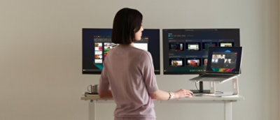 A person standing in front of computer screen.