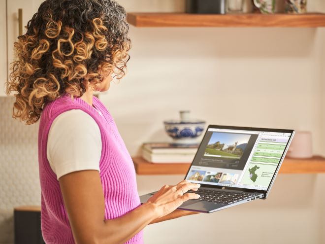 Woman using a Windows 11 laptop while standing. 