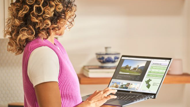 Woman smiling while using a Window PC.