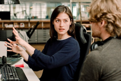 A person sitting in a chair with a person in a chair
