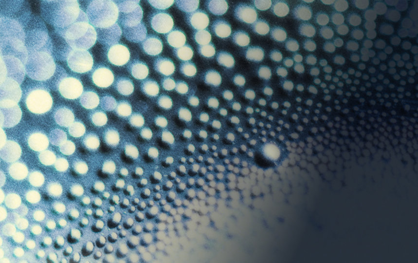 Water droplets and circles on a white and dark blue gradient background.