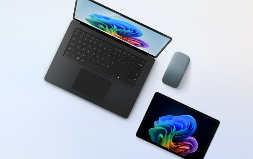A black Surface Laptop with a platinum Surface Pro and an Ocean Arc Mouse.