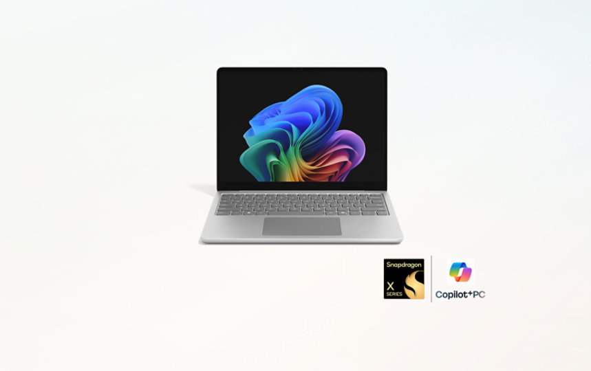 A Platinum 13-inch Surface Laptop with a badge lockup for snapdragon processors and CoPilot + PC.