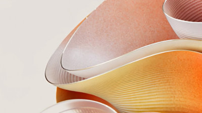 Abstract illustration of flowing ribbons in pinks and oranges.