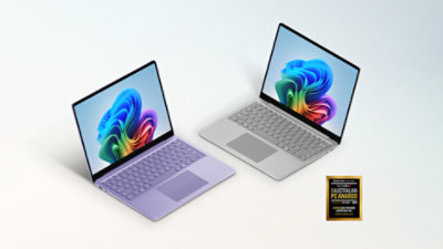 A Violet 13-inch Surface Laptop and a Platinum 13-inch Surface Laptop with the logo for the TechRadar 2026 Australian PC Awards.