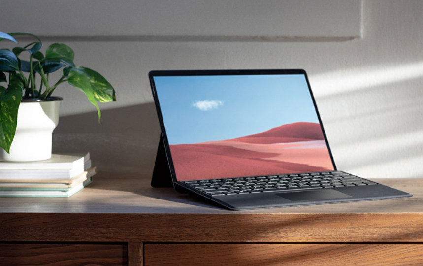 Surface Pro X with keyboard attached, sitting on a desk.