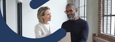 Two people looking at a laptop.