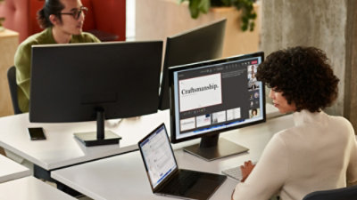 People working at desks with computer monitors
