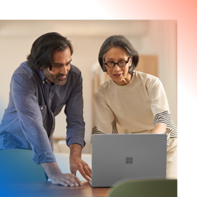 Two persons discussing while working on the laptop