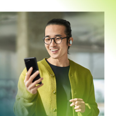 A person wearing spectacles checking his phone