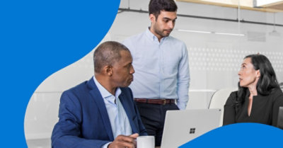 Three coworkers having a conversation in an office