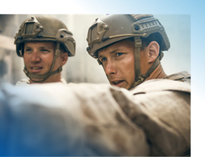A couple of men wearing military helmets.
