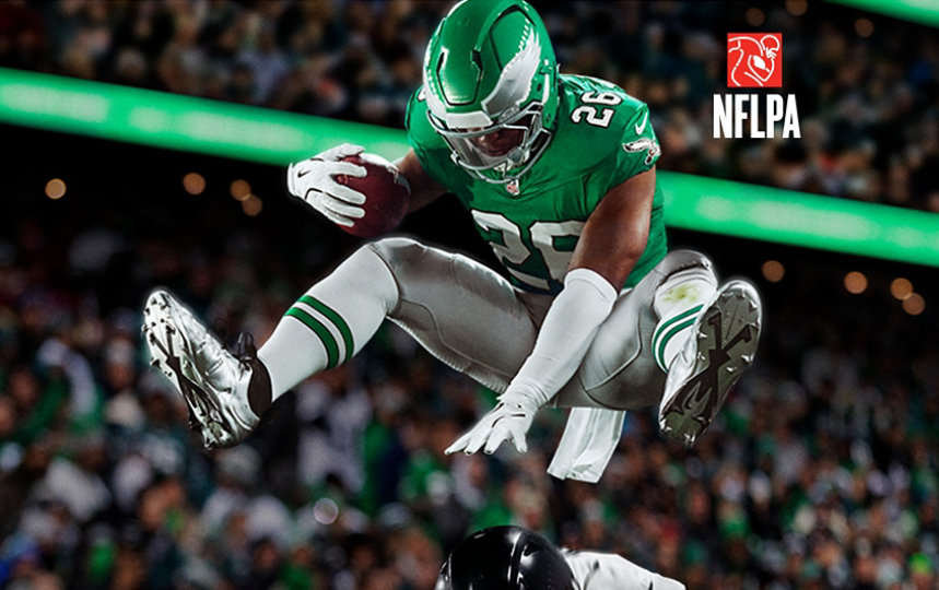 Saquon Barkley, Philadelphia Eagles Running Back, hurdles over a defender.